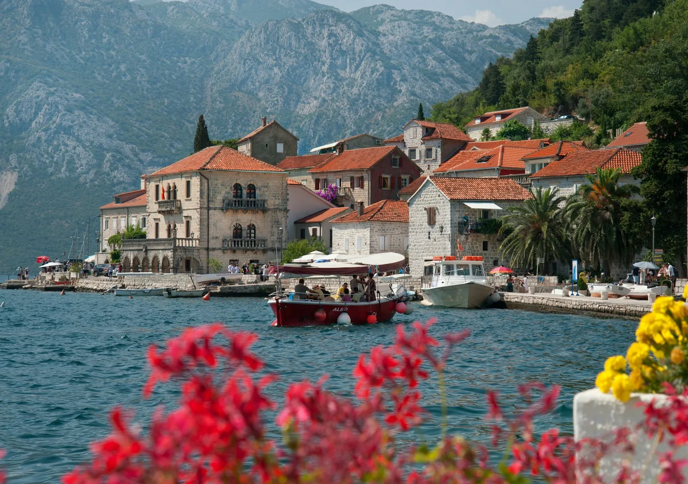 Historic stone buildings and boats along the Perast waterfront in Boka Bay